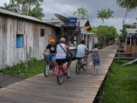 People ride bicycles in the streets of the city known as the city of bicycles, located at the mouth of the Amazon River, in Afua, Para, Braz...