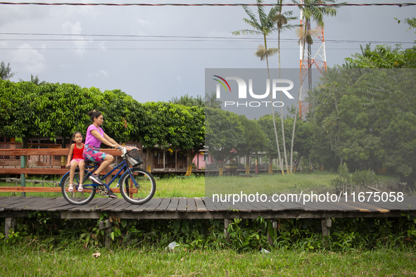 People ride bicycles in the streets of the city known as the city of bicycles, located at the mouth of the Amazon River, in Afua, Para, Braz...