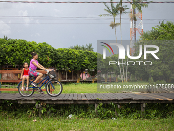 People ride bicycles in the streets of the city known as the city of bicycles, located at the mouth of the Amazon River, in Afua, Para, Braz...