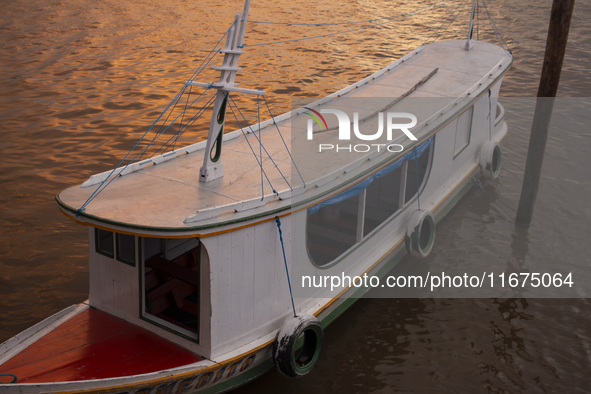 A typical Amazonian boat is at the mouth of the Amazon River in Afua, Para, Brazil, on October 1, 2024, during the evening. 