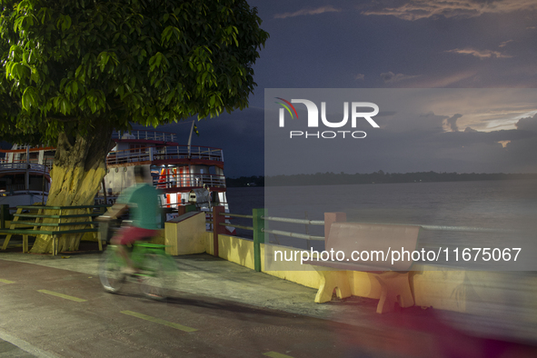 A man rides a bicycle at the mouth of the Amazon River in Afua, Para, Brazil, on October 1, 2024. 