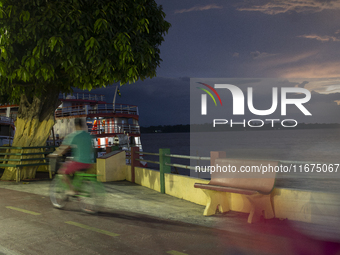 A man rides a bicycle at the mouth of the Amazon River in Afua, Para, Brazil, on October 1, 2024. (