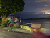 A man rides a bicycle at the mouth of the Amazon River in Afua, Para, Brazil, on October 1, 2024. (