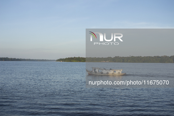 A typical Amazonian boat sails at the mouth of the Amazon River in Afua, Para, Brazil, on October 2, 2024. 