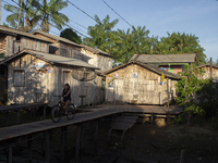 People ride bicycles in the streets of the city known as the city of bicycles, located at the mouth of the Amazon River, in Afua, Para, Braz...