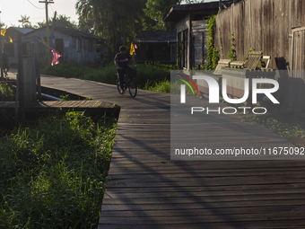 People ride bicycles in the streets of the city known as the city of bicycles, located at the mouth of the Amazon River, in Afua, Para, Braz...