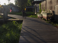 People ride bicycles in the streets of the city known as the city of bicycles, located at the mouth of the Amazon River, in Afua, Para, Braz...