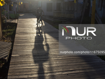 People ride bicycles in the streets of the city known as the city of bicycles, located at the mouth of the Amazon River, in Afua, Para, Braz...