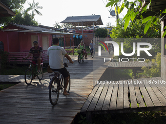 People ride bicycles in the streets of the city known as the city of bicycles, located at the mouth of the Amazon River, in Afua, Para, Braz...