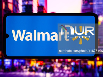 Walmart logo is screened on a mobile phone for illustration photo. Krakow, Poland on October 17th, 2024. (