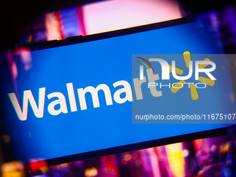 Walmart logo is screened on a mobile phone for illustration photo. Krakow, Poland on October 17th, 2024. (