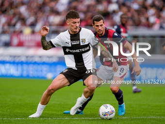 Dennis Man of Parma Calcio 1903 and Remo Freuler of Bologna FC compete for the ball during the Serie A Enilive match between Bologna FC and...