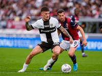 Dennis Man of Parma Calcio 1903 and Remo Freuler of Bologna FC compete for the ball during the Serie A Enilive match between Bologna FC and...