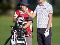 Rikuya Hoshino of Japan talks with his caddie on the 12th hole on day one of the Estrella Damm N.A. Andalucia Masters 2024 at Real Club de G...