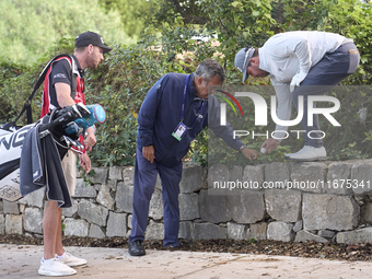 In San Roque, Spain, on October 17, 2024, Thriston Lawrence of South Africa speaks to a referee before he plays his third shot on the 14th h...