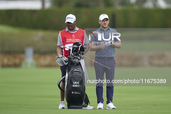 Lukas Nemecz of Austria talks with his caddie on the 14th hole on day one of the Estrella Damm N.A. Andalucia Masters 2024 at Real Club de G...