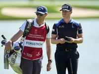 Calum Hill of Scotland talks with his caddie on the 16th green on day one of the Estrella Damm N.A. Andalucia Masters 2024 at Real Club de G...