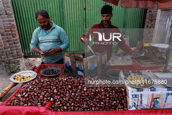 Vendors sell chestnuts and wait for customers in Srinagar, Jammu and Kashmir, India, on October 17, 2024. 