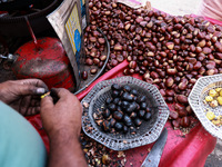 Vendors sell chestnuts and wait for customers in Srinagar, Jammu and Kashmir, India, on October 17, 2024. (