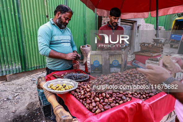 Vendors sell chestnuts and wait for customers in Srinagar, Jammu and Kashmir, India, on October 17, 2024. 