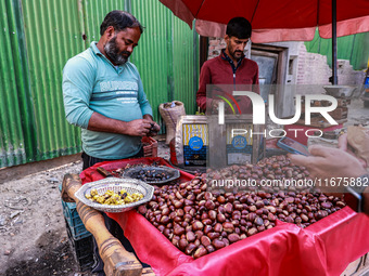 Vendors sell chestnuts and wait for customers in Srinagar, Jammu and Kashmir, India, on October 17, 2024. (