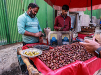 Vendors sell chestnuts and wait for customers in Srinagar, Jammu and Kashmir, India, on October 17, 2024. (