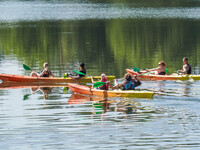 People kayak on rented kayaks on Sudomie Lake in the Cassubia region, Poland, on July 20, 2024. (