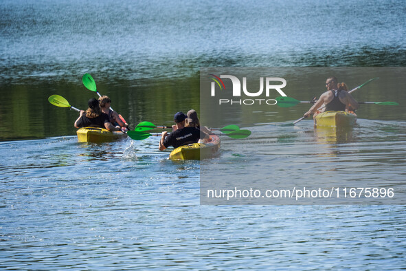 People kayak on rented kayaks on Sudomie Lake in the Cassubia region, Poland, on July 20, 2024. 