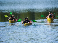 People kayak on rented kayaks on Sudomie Lake in the Cassubia region, Poland, on July 20, 2024. (