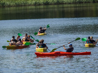 People kayak on rented kayaks on Sudomie Lake in the Cassubia region, Poland, on July 20, 2024. (