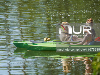 People kayak on rented kayaks on Sudomie Lake in the Cassubia region, Poland, on July 20, 2024. (