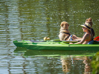 People kayak on rented kayaks on Sudomie Lake in the Cassubia region, Poland, on July 20, 2024. (