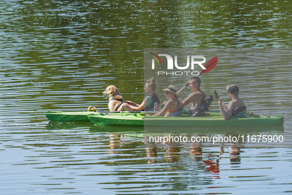 People kayak on rented kayaks on Sudomie Lake in the Cassubia region, Poland, on July 20, 2024. 