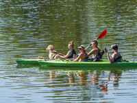 People kayak on rented kayaks on Sudomie Lake in the Cassubia region, Poland, on July 20, 2024. (