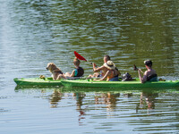 People kayak on rented kayaks on Sudomie Lake in the Cassubia region, Poland, on July 20, 2024. (