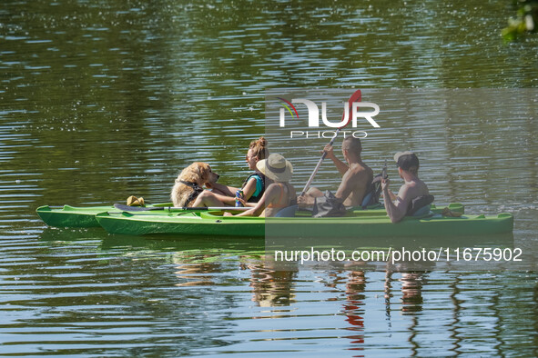 People kayak on rented kayaks on Sudomie Lake in the Cassubia region, Poland, on July 20, 2024. 