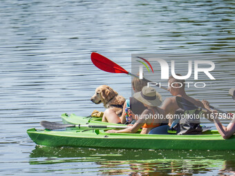 People kayak on rented kayaks on Sudomie Lake in the Cassubia region, Poland, on July 20, 2024. (