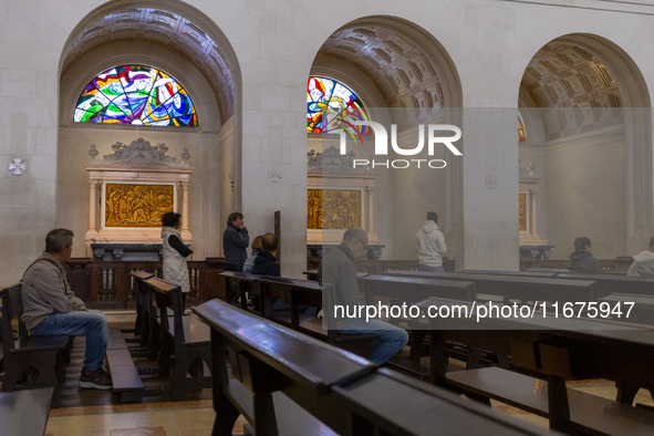 In Lisbon, Portugal, on October 17, 2024, people pray inside the Basilica of Fatima. Fatima becomes a pilgrimage destination for migrants as...