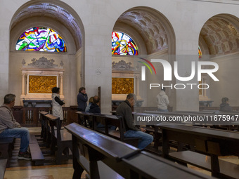 In Lisbon, Portugal, on October 17, 2024, people pray inside the Basilica of Fatima. Fatima becomes a pilgrimage destination for migrants as...