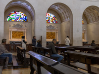 In Lisbon, Portugal, on October 17, 2024, people pray inside the Basilica of Fatima. Fatima becomes a pilgrimage destination for migrants as...