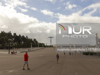 In Lisbon, Portugal, on October 17, 2024, people walk inside the Sanctuary of Fatima. Fatima becomes a pilgrimage destination for migrants,...