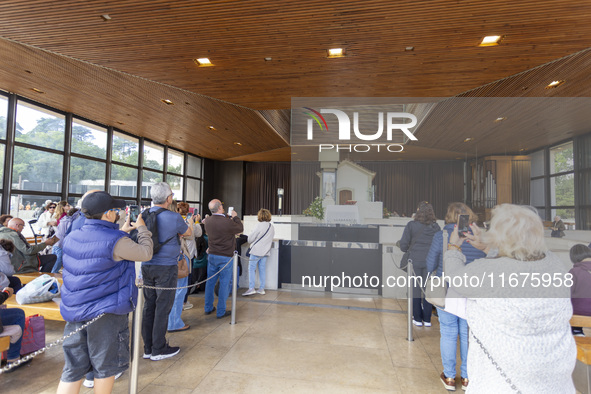 In Lisbon, Portugal, on October 17, 2024, people take pictures of the image of the Virgin inside the chapel of the Sanctuary of Fatima. Fati...