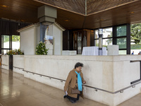 In Lisbon, Portugal, on October 17, 2024, a person walks on her knees near the image of the Virgin inside the chapel of the Sanctuary of Fat...