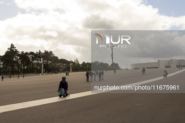 In Lisbon, Portugal, on October 17, 2024, a person walks on her knees near the chapel of the Sanctuary of Fatima. Fatima becomes a pilgrimag...