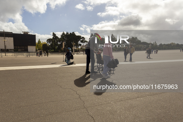 In Lisbon, Portugal, on October 17, 2024, a person walks on her knees near the chapel of the Sanctuary of Fatima. Fatima becomes a pilgrimag...