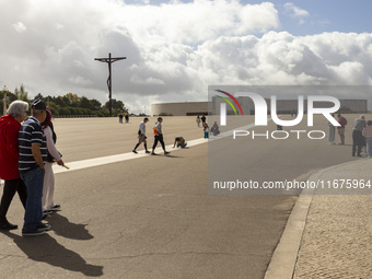 In Lisbon, Portugal, on October 17, 2024, a person walks on her knees near the chapel of the Sanctuary of Fatima. Fatima becomes a pilgrimag...