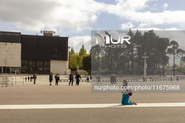 In Lisbon, Portugal, on October 17, 2024, a person walks on her knees near the chapel of the Sanctuary of Fatima. Fatima becomes a pilgrimag...