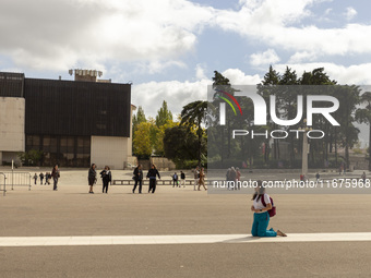 In Lisbon, Portugal, on October 17, 2024, a person walks on her knees near the chapel of the Sanctuary of Fatima. Fatima becomes a pilgrimag...