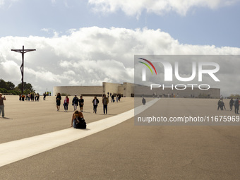 In Lisbon, Portugal, on October 17, 2024, a person walks on her knees near the chapel of the Sanctuary of Fatima. Fatima becomes a pilgrimag...