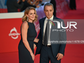 Claudia Gerini and Riccardo Sangiuliano attend the ''U.S. Palmese'' red carpet during the 19th Rome Film Festival at Auditorium Parco Della...